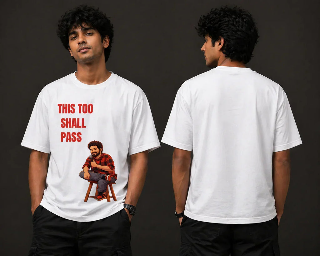 Man wearing oversized white t-shirt with 'This too shall pass' and cartoon graphic, front and back view.