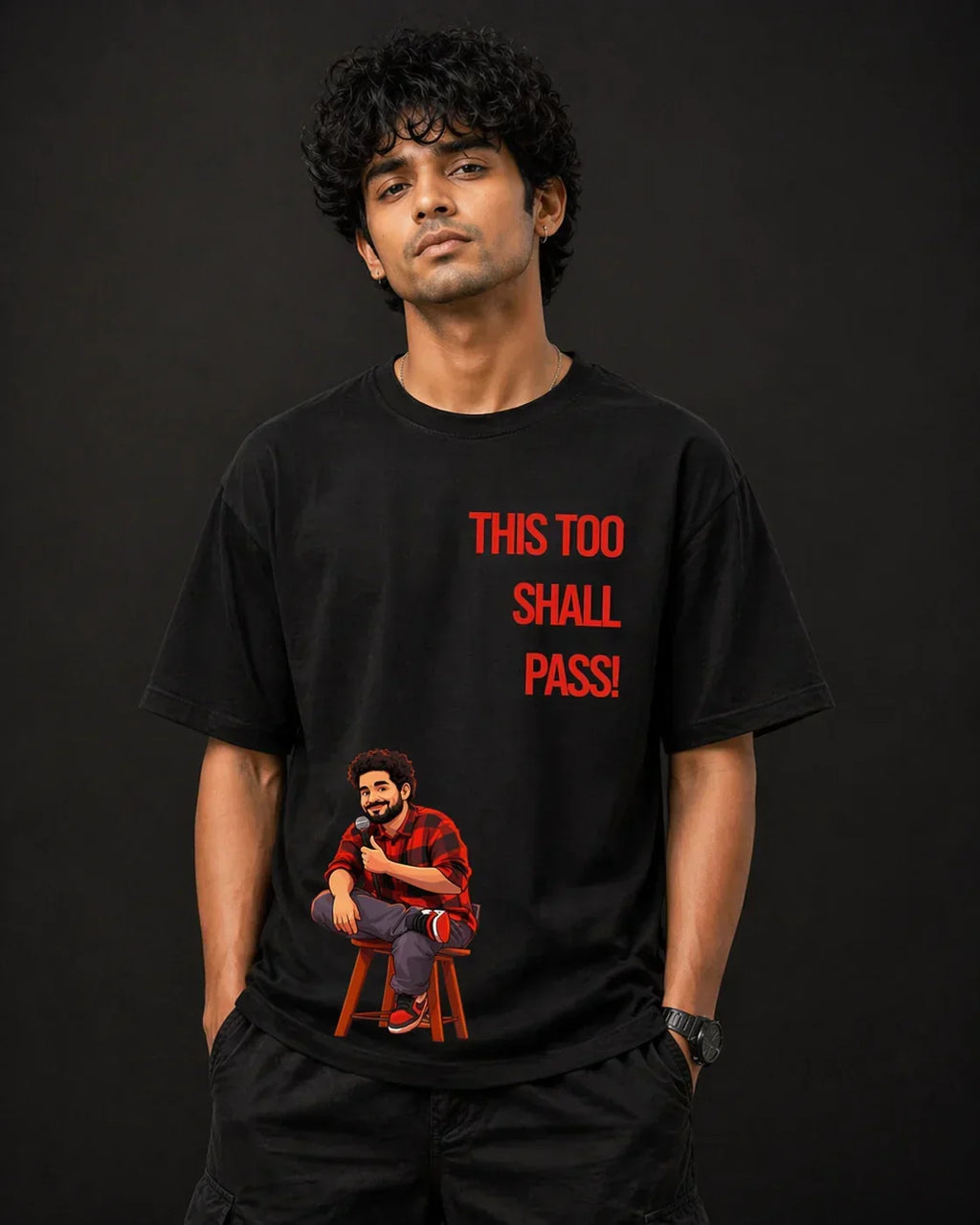 Black oversized t-shirt with 'This Too Shall Pass' quote and cartoon graphic, stylish streetwear design