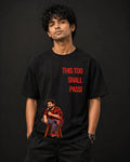 Black oversized t-shirt with 'This Too Shall Pass' quote and cartoon graphic, stylish streetwear design