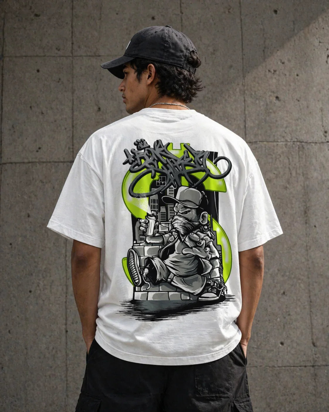 White oversized t-shirt with graffiti-style graphic of a character holding spray cans, urban street art design