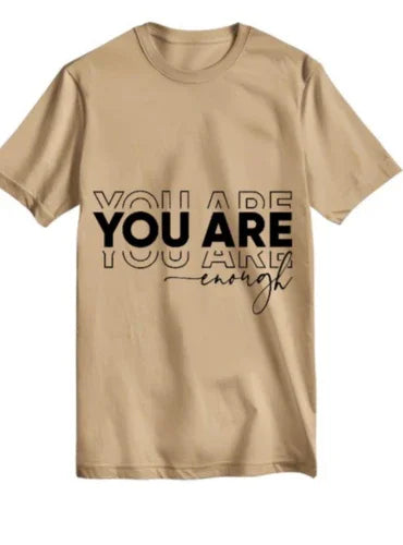 Beige oversized t-shirt with black "You Are Enough" motivational text print on front.